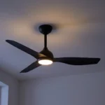 claro-whisper-dc-48-inch-ceiling-fan-black-with-led-light-on-close-up-on-dark-background